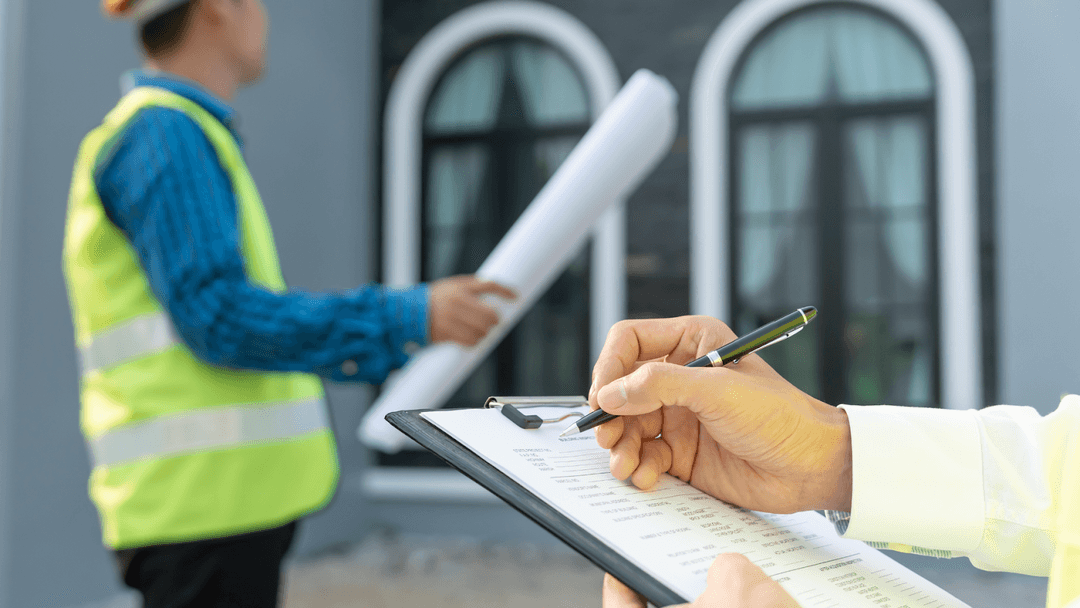 Appraiser evaluating new property structure with inspection documents