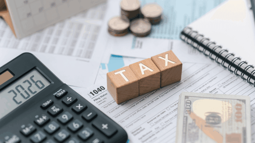 Tax concept with tax documents, calculator, and wooden blocks