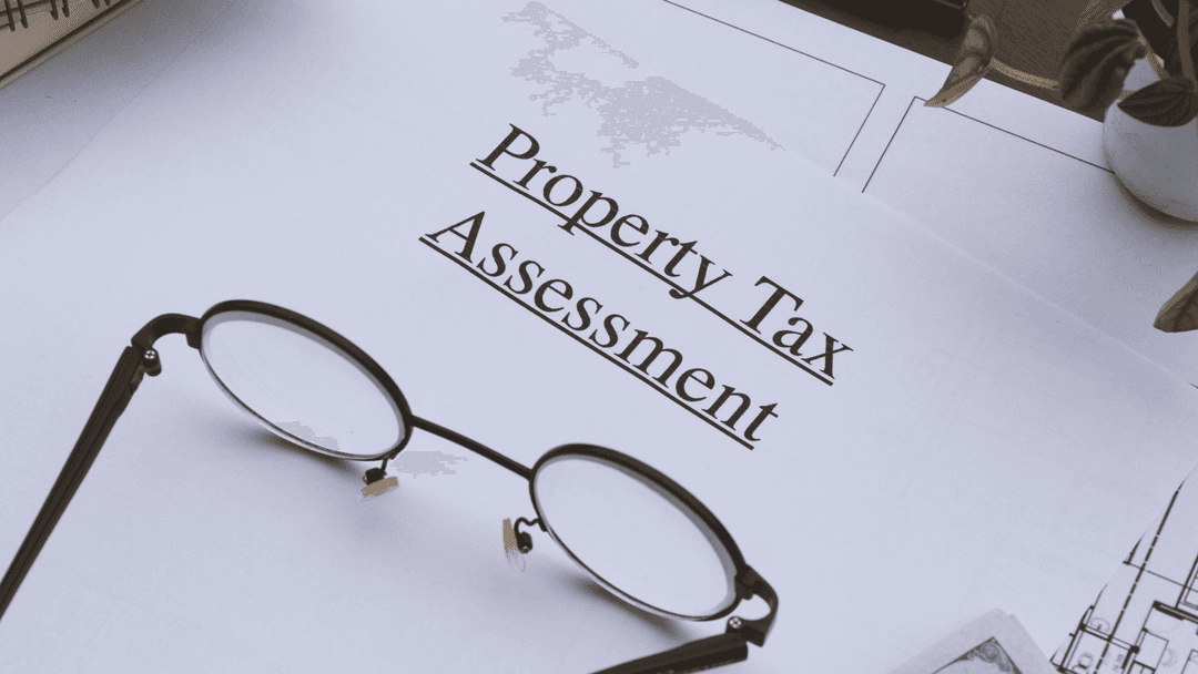 Close-up of a property tax assessment paper with glasses nearby