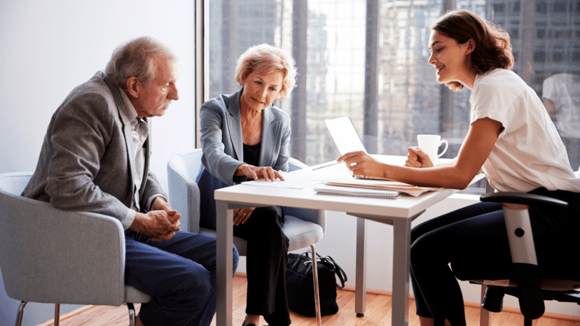 Elderly couple meeting a consultant about tax filing help