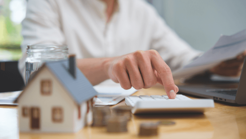 Tax adviser using a calculator to review rising property valuations