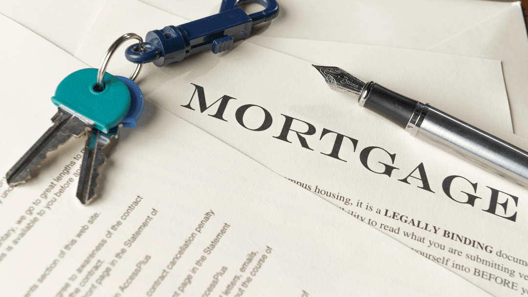 Mortgage documentation with keys and pen on it