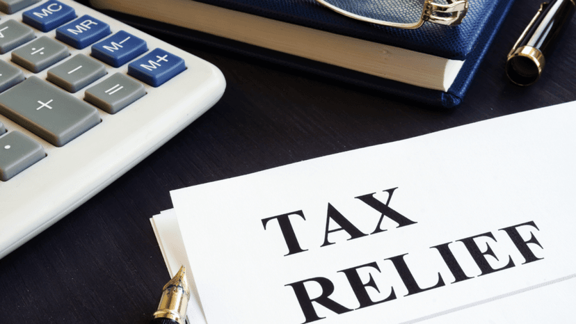 Tax relief document beside a calculator and pen on desk