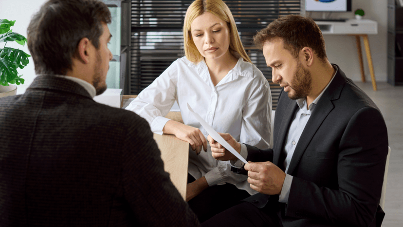Business owners reviewing property tax assessment notice with a professional consultant