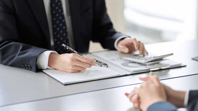 Property tax consultant reviewing financial documents and calculations with a client