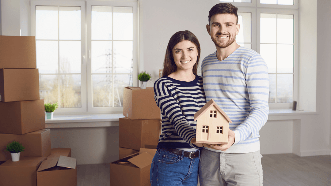 New homeowners with moving boxes after buying a home in Texas