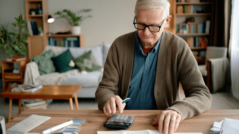 Senior homeowner reviewing property tax bill with a calculator